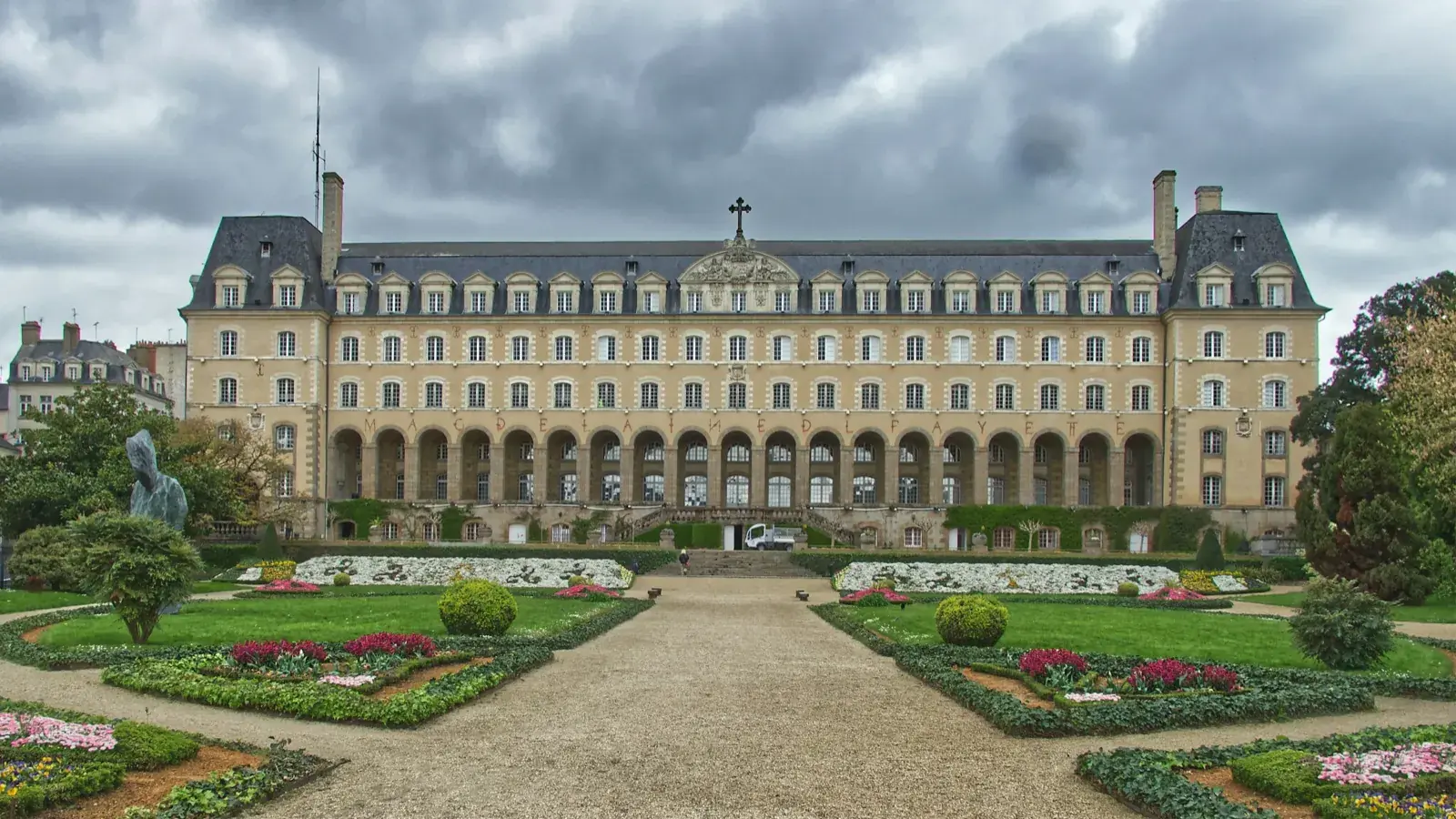 Façade du Palais Saint-Georges à Rennes et son jardin à la française, allée centrale bordée de massifs fleuris